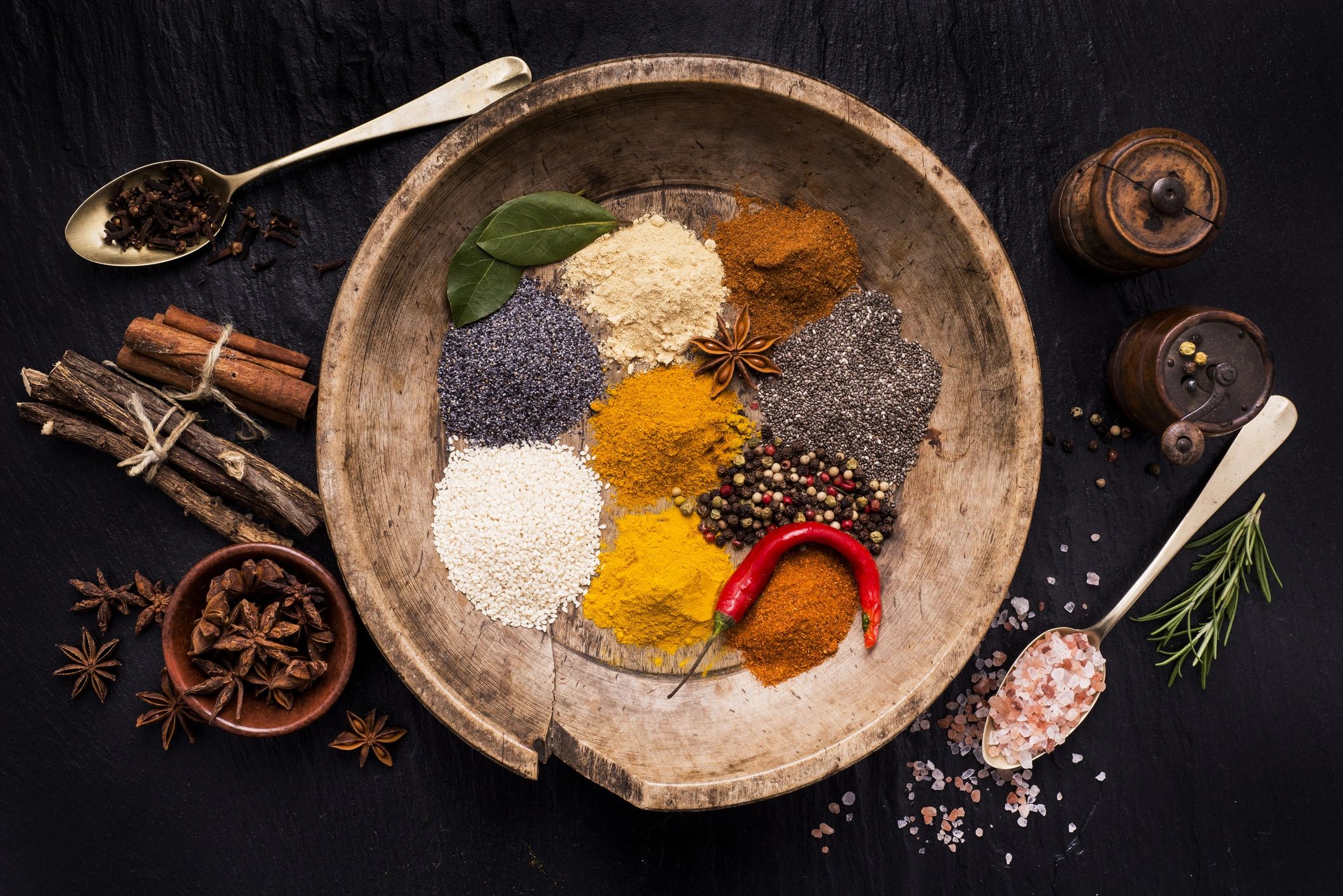 Colorful spices on a wooden plate, evoking warmth and grounded nourishment