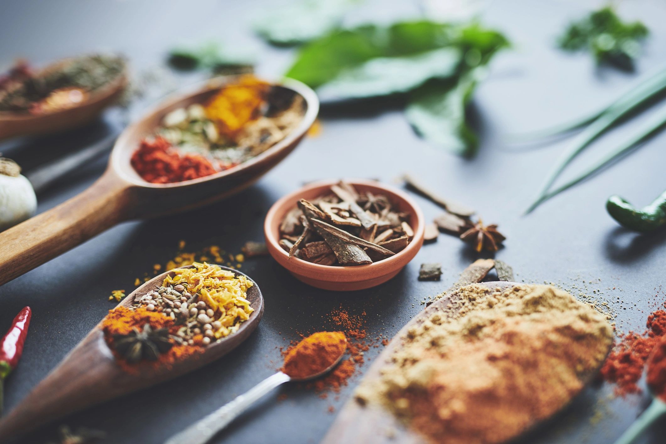 Assortment of colorful spices in bowls, evoking Ayurvedic nourishment and warmth