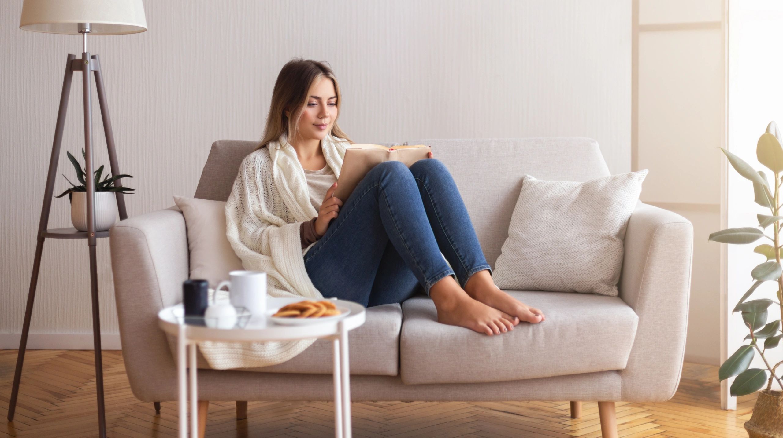Woman reading at home, learning and integrating new wellness knowledge