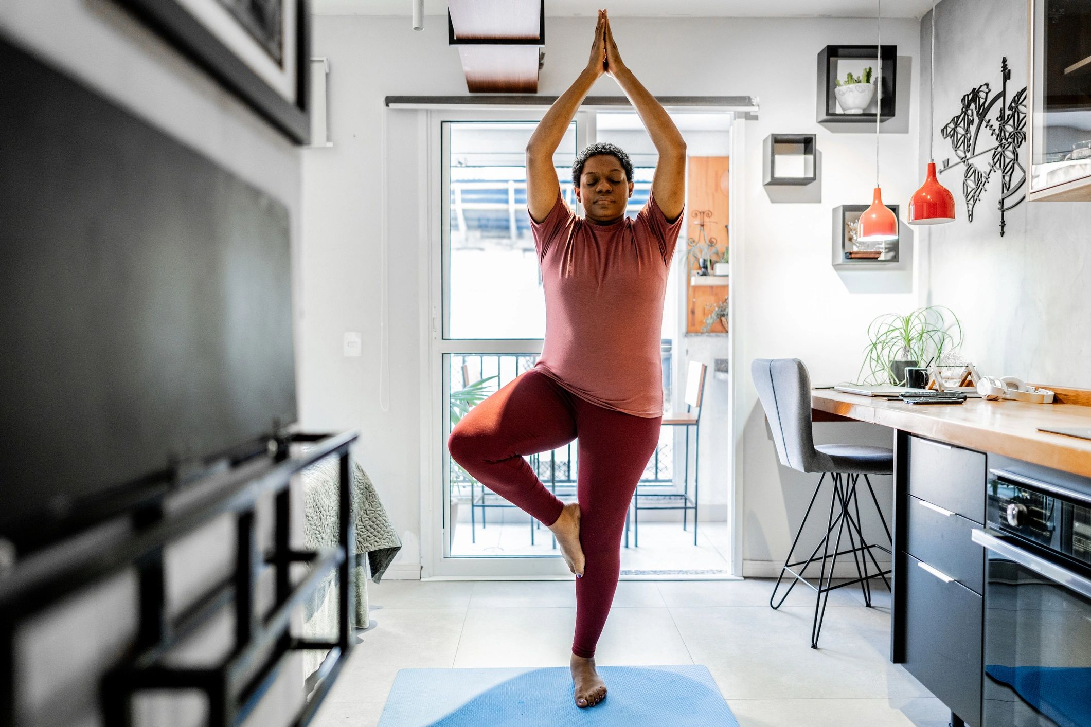 Mature woman stretching at home for gentle wellness