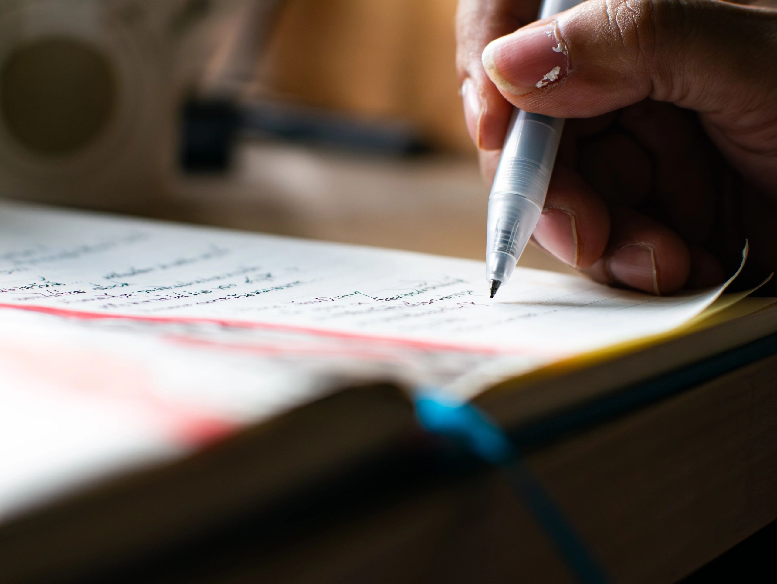 Hands writing notes in a notebook, learning and reflecting